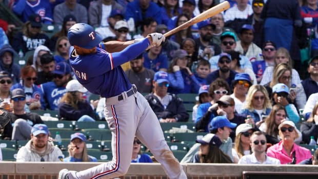 Apr 9, 2023; Chicago, Illinois, USA; Texas Rangers center fielder Bubba Thompson (8) hits a one run triple during the sixth inning at Wrigley Field. Mandatory Credit: David Banks-USA TODAY Sports
